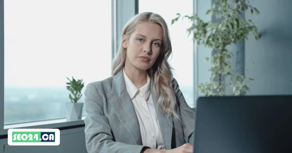 Lawyer working on a laptop in a high-rise office overlooking the city, SEO24 lawyer SEO service in Toronto